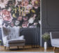 Sessel und Sofa vor einer Wand mit Blumenmuster.